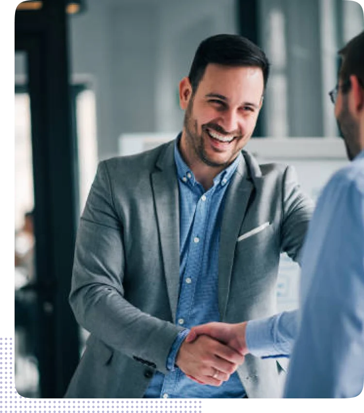 Two professionals shaking hands in an office, representing trends shaping the future of mobile app development company in usa